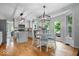 Modern kitchen with stainless steel appliances, center island, and hardwood floors at 11956 Glen Cove Dr, Indianapolis, IN 46236