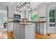 Bright kitchen features granite countertops, stainless steel appliances, and a center island at 11956 Glen Cove Dr, Indianapolis, IN 46236