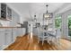 Eat-in kitchen boasts modern lighting fixtures, stainless steel appliances, and hardwood floors at 11956 Glen Cove Dr, Indianapolis, IN 46236