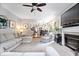 Comfortable living room with fireplace, ceiling fan, and open layout with easy access to the kitchen at 11956 Glen Cove Dr, Indianapolis, IN 46236