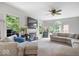 Spacious living room with large windows, fireplace, and comfortable sectional sofa at 11956 Glen Cove Dr, Indianapolis, IN 46236