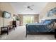 The large bedroom has a ceiling fan, bay window, dresser and a wall-mounted TV at 11956 Glen Cove Dr, Indianapolis, IN 46236