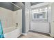 Beautiful bathroom featuring double sinks, bathtub with tile surround, and modern lighting at 12277 E Harvest Glen Dr, Indianapolis, IN 46229