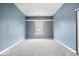 Empty bedroom featuring natural lighting, gray walls, and neutral carpeting at 12277 E Harvest Glen Dr, Indianapolis, IN 46229