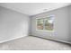 Spacious bedroom featuring natural lighting, gray walls, and neutral carpeting at 12277 E Harvest Glen Dr, Indianapolis, IN 46229
