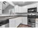 Bright kitchen features white cabinetry and stainless steel appliances at 12277 E Harvest Glen Dr, Indianapolis, IN 46229