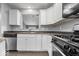 Modern kitchen features stainless steel appliances, white cabinets, and stone countertops at 12277 E Harvest Glen Dr, Indianapolis, IN 46229