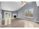 Bright living room features French doors to the backyard, fireplace, and vaulted ceiling at 12277 E Harvest Glen Dr, Indianapolis, IN 46229