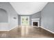 Spacious living room featuring a cozy fireplace, wood floors, and access to the backyard at 12277 E Harvest Glen Dr, Indianapolis, IN 46229