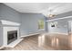 Living room with fireplace, ceiling fan, and wood floors at 12277 E Harvest Glen Dr, Indianapolis, IN 46229