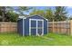 Blue storage shed in the fenced backyard offers additional outdoor storage space at 12277 E Harvest Glen Dr, Indianapolis, IN 46229