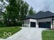 Exterior view of the property showing the attached garage, driveway and the home's architectural style at 12511 Lowery Way, Fishers, IN 46037