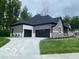 Exterior view of the property showing the attached garage, driveway and the home's architectural style at 12511 Lowery Way, Fishers, IN 46037