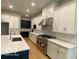 Spacious kitchen featuring white cabinetry, quartz countertops, stainless steel appliances, and a center island at 12511 Lowery Way, Fishers, IN 46037