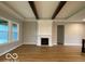 Spacious living room showcases hardwood flooring, a fireplace, and exposed ceiling beams at 12511 Lowery Way, Fishers, IN 46037