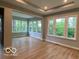 Bright living room features large windows, filling the space with natural light and showcasing backyard views at 12511 Lowery Way, Fishers, IN 46037