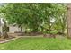 Expansive backyard retreat featuring mature trees, patio, and cozy seating area for relaxation and outdoor entertainment at 126 N Darlington St, Jamestown, IN 46147