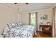 Cozy bedroom with hardwood floors, a large window, and a comfortable bed with patterned quilt at 126 N Darlington St, Jamestown, IN 46147
