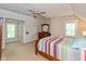 Bedroom with a sloped ceiling, fan, windows, carpet, and a wooden dresser at 126 N Darlington St, Jamestown, IN 46147