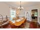 Elegant dining room with a wooden table and chairs, chandelier lighting, and hardwood floors at 126 N Darlington St, Jamestown, IN 46147
