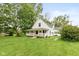 Charming white two-story home featuring a cozy front porch, mature trees, and a well-manicured lawn at 126 N Darlington St, Jamestown, IN 46147