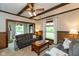 Inviting living room featuring a beamed ceiling, wood trim, and ample natural light from large windows at 126 N Darlington St, Jamestown, IN 46147