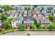 Aerial view of homes with colorful garages and manicured lawns in a planned community at 12999 Deerstyne Green St, Carmel, IN 46032