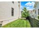 A view of the backyard's lush green grass and black metal fence under a sunny sky at 12999 Deerstyne Green St, Carmel, IN 46032