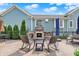 Backyard stone fireplace with rocking chairs, perfect for relaxing in the outdoor space at 12999 Deerstyne Green St, Carmel, IN 46032