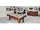 Spacious basement with a pool table, air hockey table, comfortable sofa, and sports decor at 12999 Deerstyne Green St, Carmel, IN 46032