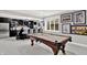 Basement bar with a refrigerator, wine rack, bar stools, and a pool table at 12999 Deerstyne Green St, Carmel, IN 46032