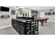 Entertaining basement area featuring a wet bar, wine rack, pool table, and comfortable seating, perfect for gatherings at 12999 Deerstyne Green St, Carmel, IN 46032
