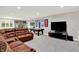 Basement entertainment room featuring a large leather sectional, pool table, media center, and decorative wall art at 12999 Deerstyne Green St, Carmel, IN 46032