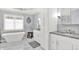 A soaking tub with a chandelier above offers a place to relax in this bright bathroom at 12999 Deerstyne Green St, Carmel, IN 46032