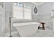 Modern bathroom featuring a freestanding tub and marble tile at 12999 Deerstyne Green St, Carmel, IN 46032