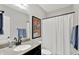 Bathroom with granite counters, dark cabinets, white shower curtain, and blue towels at 12999 Deerstyne Green St, Carmel, IN 46032
