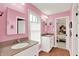 Bright pink bathroom features double vanity and leads into a bedroom at 12999 Deerstyne Green St, Carmel, IN 46032