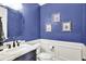 Stylish powder room with dark vanity, marble countertop, modern fixtures, and decorative wall art at 12999 Deerstyne Green St, Carmel, IN 46032