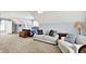 Spacious bedroom featuring a sitting area, plush carpeting, and a comfortable bed with blue and white patterned bedding at 12999 Deerstyne Green St, Carmel, IN 46032