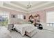 Bright bedroom with a tray ceiling, carpeted floor and comfortable bed at 12999 Deerstyne Green St, Carmel, IN 46032
