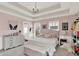 Charming bedroom with a tray ceiling, cozy decor, and ample natural light at 12999 Deerstyne Green St, Carmel, IN 46032