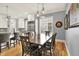 Cozy dining room with a wooden table, hardwood flooring, and modern pendant lighting at 12999 Deerstyne Green St, Carmel, IN 46032