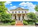 Charming two-story white brick home with a welcoming front porch and landscaped yard at 12999 Deerstyne Green St, Carmel, IN 46032