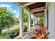 Inviting front porch with rocking chairs and decorative planters, perfect for relaxing outdoors at 12999 Deerstyne Green St, Carmel, IN 46032