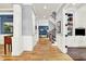 Hallway with wood floors, white trim, stairway and built-in shelving offers bright and open living space at 12999 Deerstyne Green St, Carmel, IN 46032