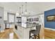 Spacious open kitchen featuring a large island with seating, stainless steel appliances, and wood floors at 12999 Deerstyne Green St, Carmel, IN 46032