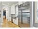 Kitchen featuring stainless steel fridge and appliances, marble backsplash, granite counters and white cabinets at 12999 Deerstyne Green St, Carmel, IN 46032