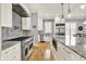 Gourmet kitchen featuring a professional-grade gas range, stainless steel appliances, and granite countertops at 12999 Deerstyne Green St, Carmel, IN 46032