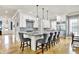 Beautiful kitchen with a large center island, stainless steel appliances, tile backsplash, and hardwood floors at 12999 Deerstyne Green St, Carmel, IN 46032