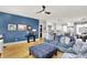 Spacious living room offers hardwood floors, comfortable blue sofa, and view to the kitchen and dining area at 12999 Deerstyne Green St, Carmel, IN 46032